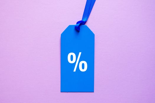 percent symbol on the blue price tag, pink background photo