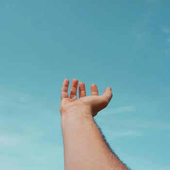 hand up gesturing in the blue sky, feelings and emotions photo