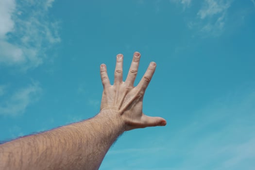 hand up gesturing in the blue sky, feelings and emotions photo