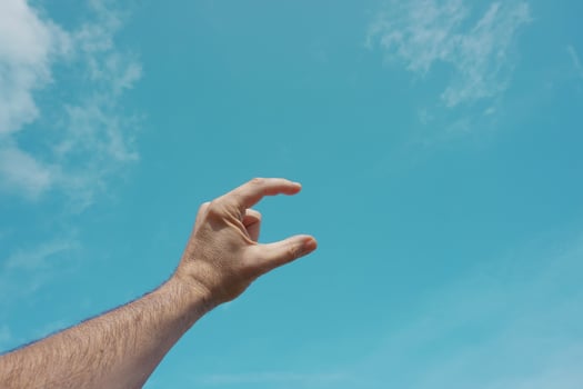 hand up gesturing in the blue sky, feelings and emotions photo