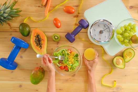 Woman prepares a healthy meal with salad and orange juice photo