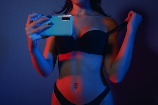 woman in lingerie records a movie for web portal photo