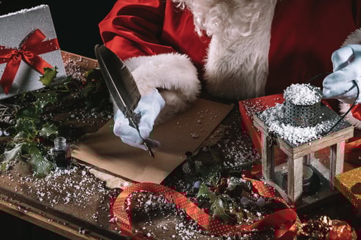 Santa claus writes a letter good wishes for Christmas gifts photo