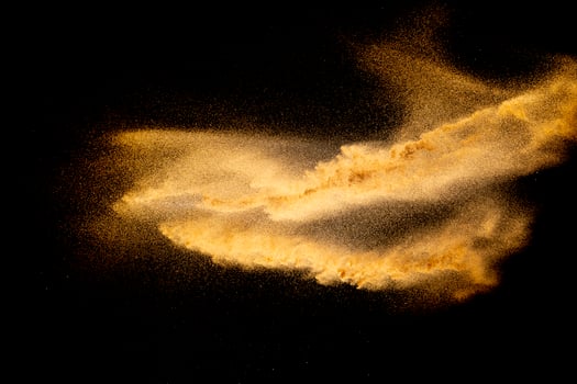 Dry river sand explosion.Brown color sand splash against black background. photo