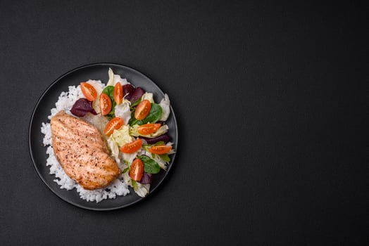 Delicious healthy breakfast consisting of chicken, rice, greens and cherry tomatoes photo