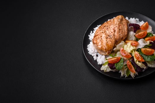 Delicious healthy breakfast consisting of chicken, rice, greens and cherry tomatoes photo