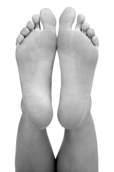 Closeup shot of female feet, isolated on white background photo