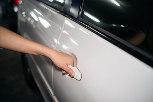 Business woman hand open person white car. Automobile vehicle female owner catching a door handle. Driver, service, lock, automotive insurance concept. photo
