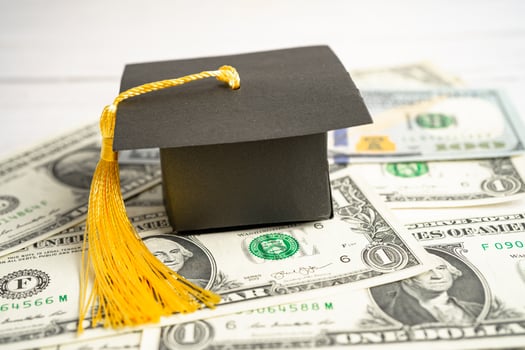 Graduation gap hat on Euro and US dollar banknotes money, Education study fee learning teach concept. photo