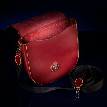 Leather red bag on a dark background. photo