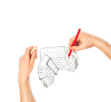 Hands drawing big house on a white photo