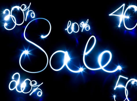 Glowing inscription SALE on a black photo