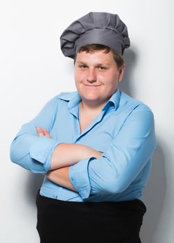 Plump cook on gray wall photo