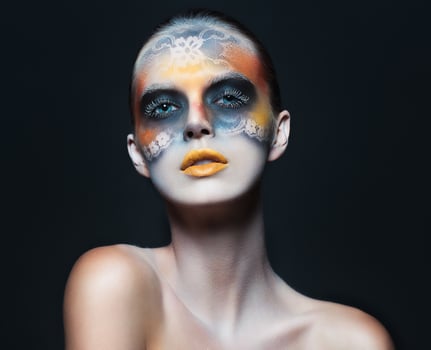 Portrait of beautiful glamor girl with dark eye make-up in the form of lace and orange lips photo