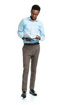 Happy african american college student with books in his hands  standing on white photo