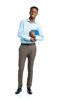Happy african american college student with books in his hands standing on white photo