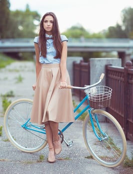Young beautiful, elegantly dressed woman with bicycle photo