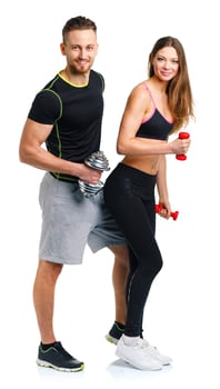 Sport couple - man and woman with dumbbells on the white photo