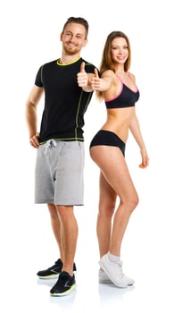 Athletic man and woman after fitness exercise with thumbs up on the white photo