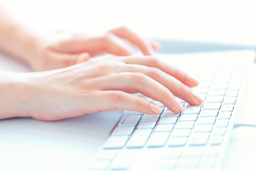 Female hands or woman office worker typing on the keyboard photo