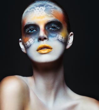 Portrait of beautiful glamor girl with dark eye make-up in the form of lace and orange lips photo