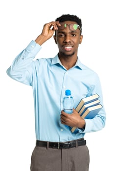 Happy african american college student with books and bottle of water in his hands photo