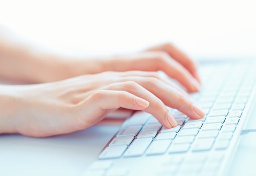 Female hands or woman office worker typing on the keyboard photo
