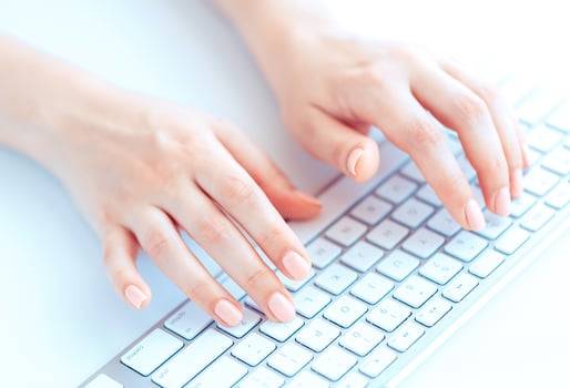 Female hands or woman office worker typing on the keyboard photo