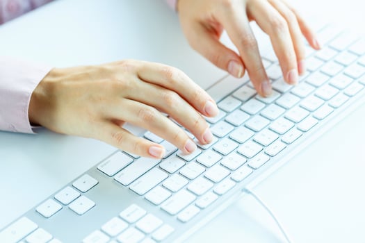 Woman office worker typing on the keyboard photo