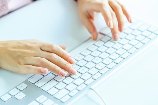 Woman office worker typing on the keyboard photo