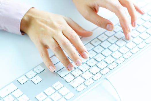 Woman office worker typing on the keyboard photo