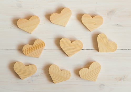 Wooden hearts on white wooden background photo