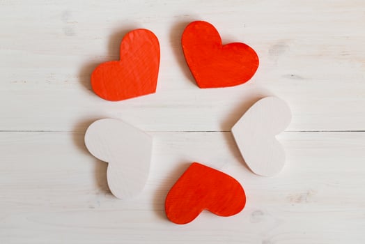 Red and white hearts on white wooden background photo