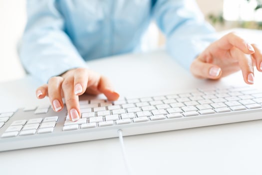 Woman office worker typing on the keyboard photo