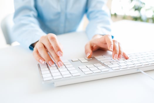 Woman office worker typing on the keyboard photo