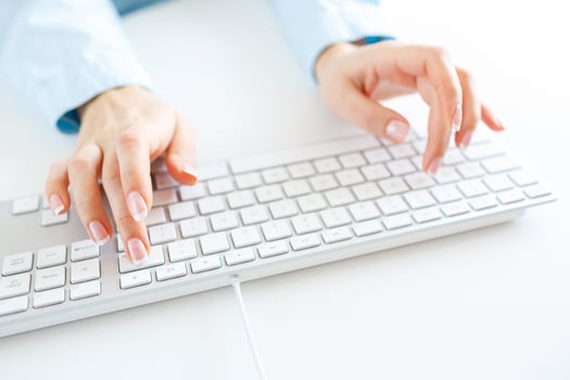 Woman office worker typing on the keyboard photo