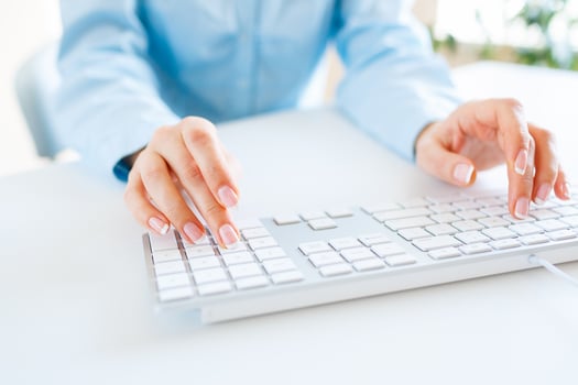 Woman office worker typing on the keyboard photo