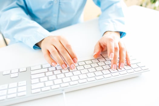 Woman office worker typing on the keyboard photo