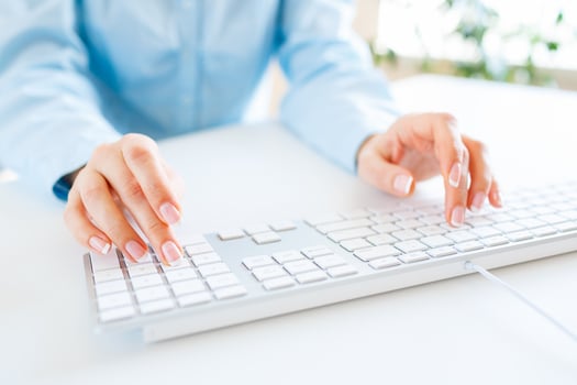 Woman office worker typing on the keyboard photo