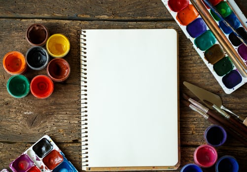 Paper, watercolors and paint brush on wooden background photo