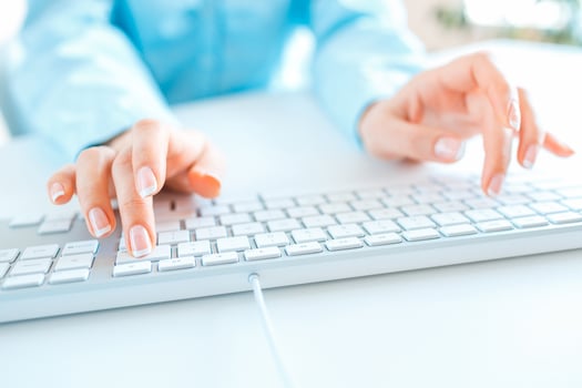 Woman office worker typing on the keyboard photo