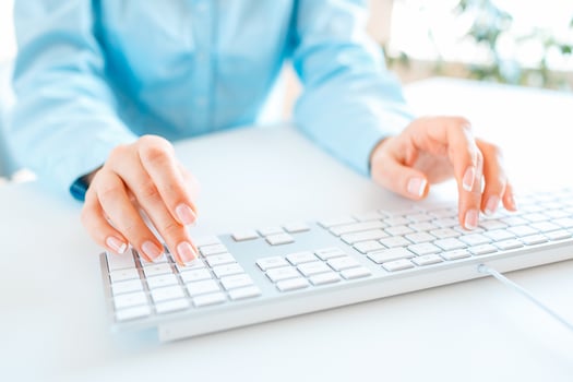 Woman office worker typing on the keyboard photo
