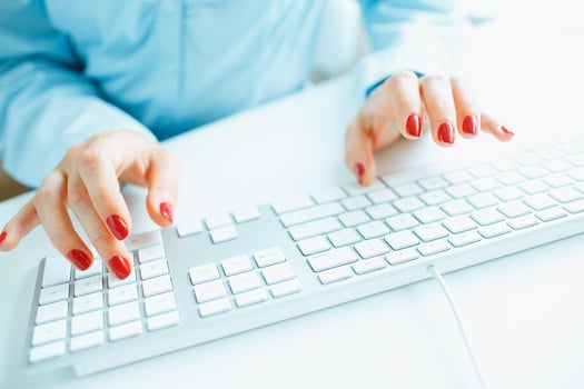 Woman office worker typing on the keyboard photo