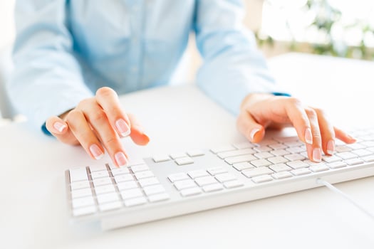 Woman office worker typing on the keyboard photo