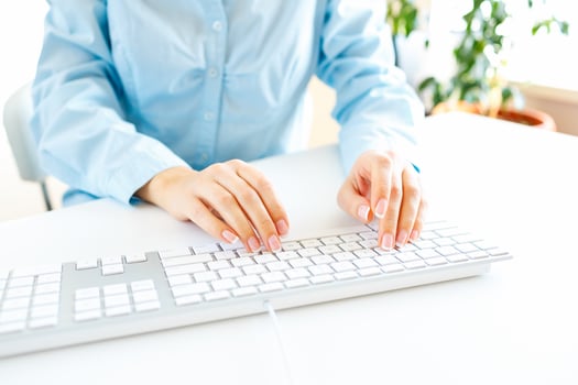 Woman office worker typing on the keyboard photo