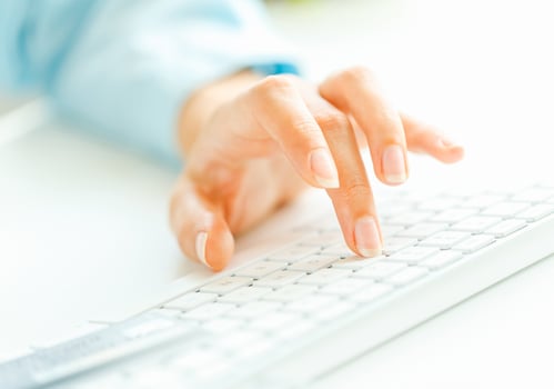 Woman office worker typing on the keyboard photo