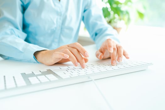 Woman office worker typing on the keyboard photo
