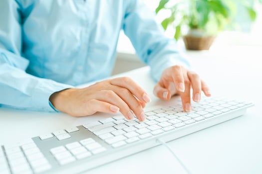 Woman office worker typing on the keyboard photo
