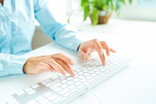 Woman office worker typing on the keyboard photo