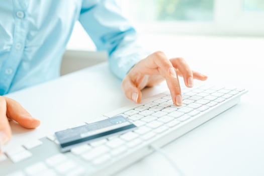 Female hands using computer and credit card on it photo